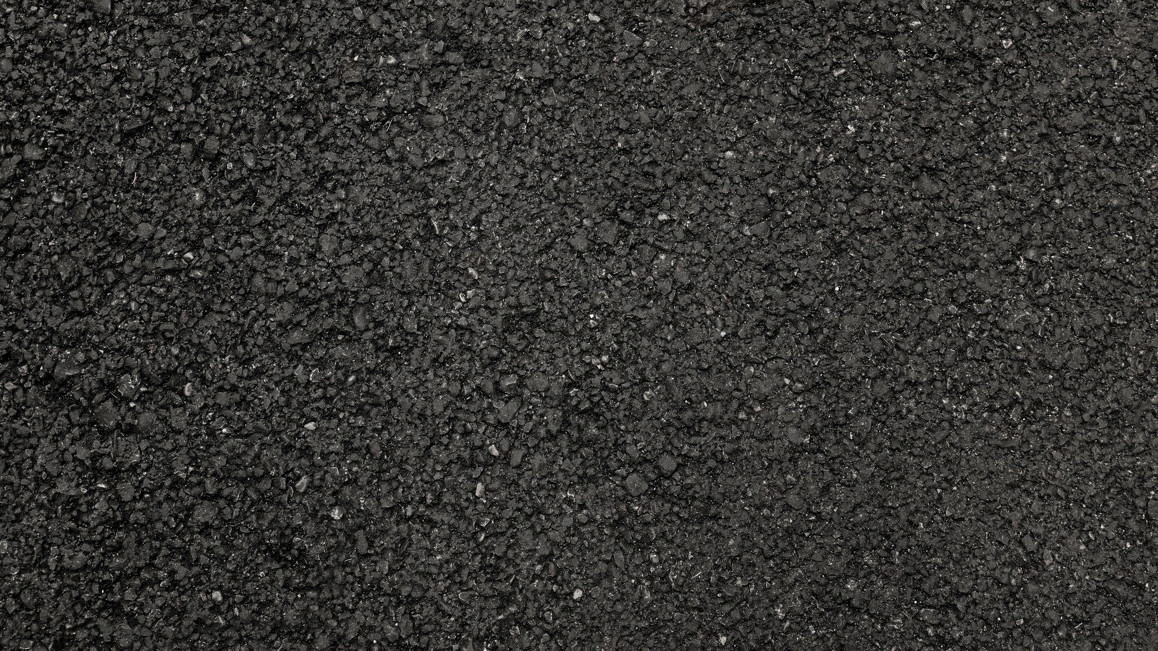 Asphalt Strassenoberfläche Nahaufnahme einer schwarzen Asphaltoberfläche ohne Markierungen.